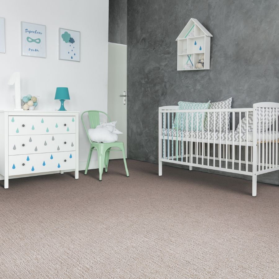 carpet in baby room with green, blue, and white colors with green chair